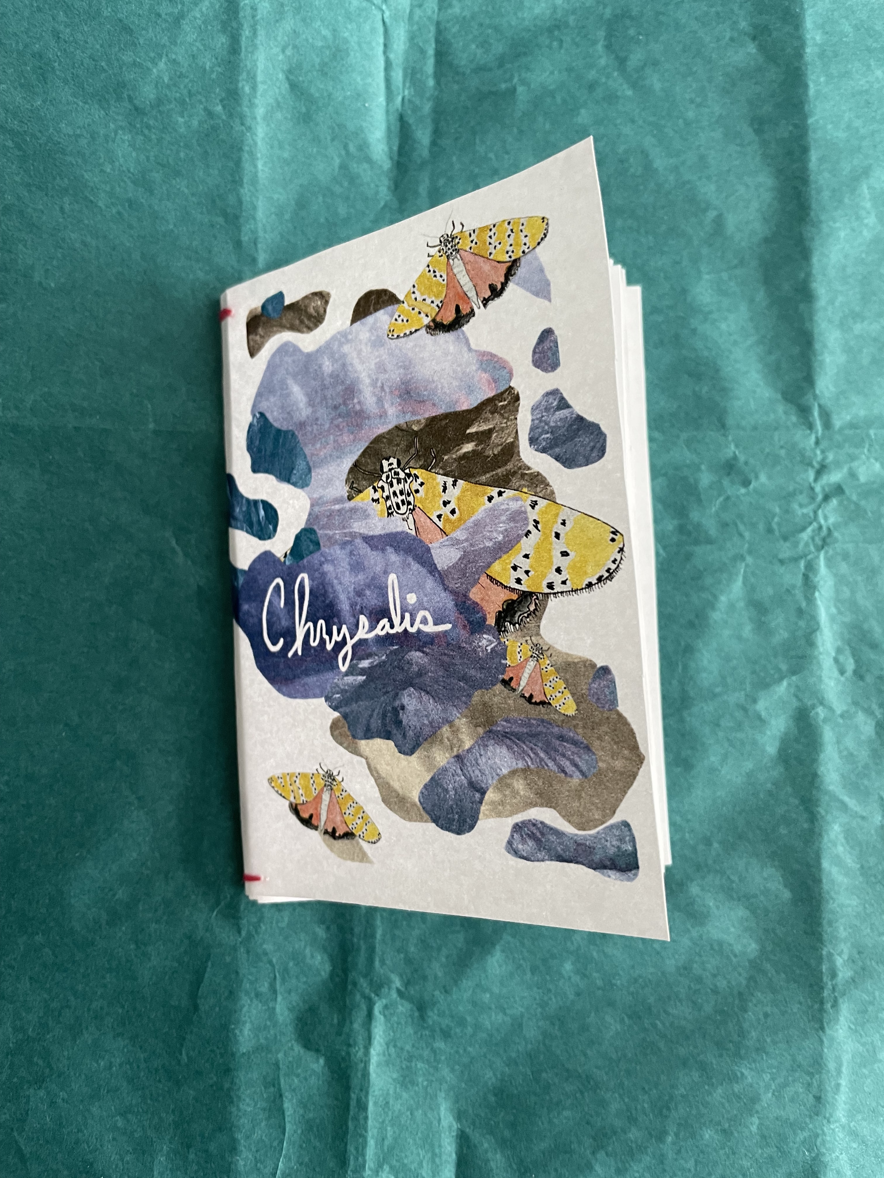 a poetry zine featuring a collage and a watercolor moth on the cover against a teal background