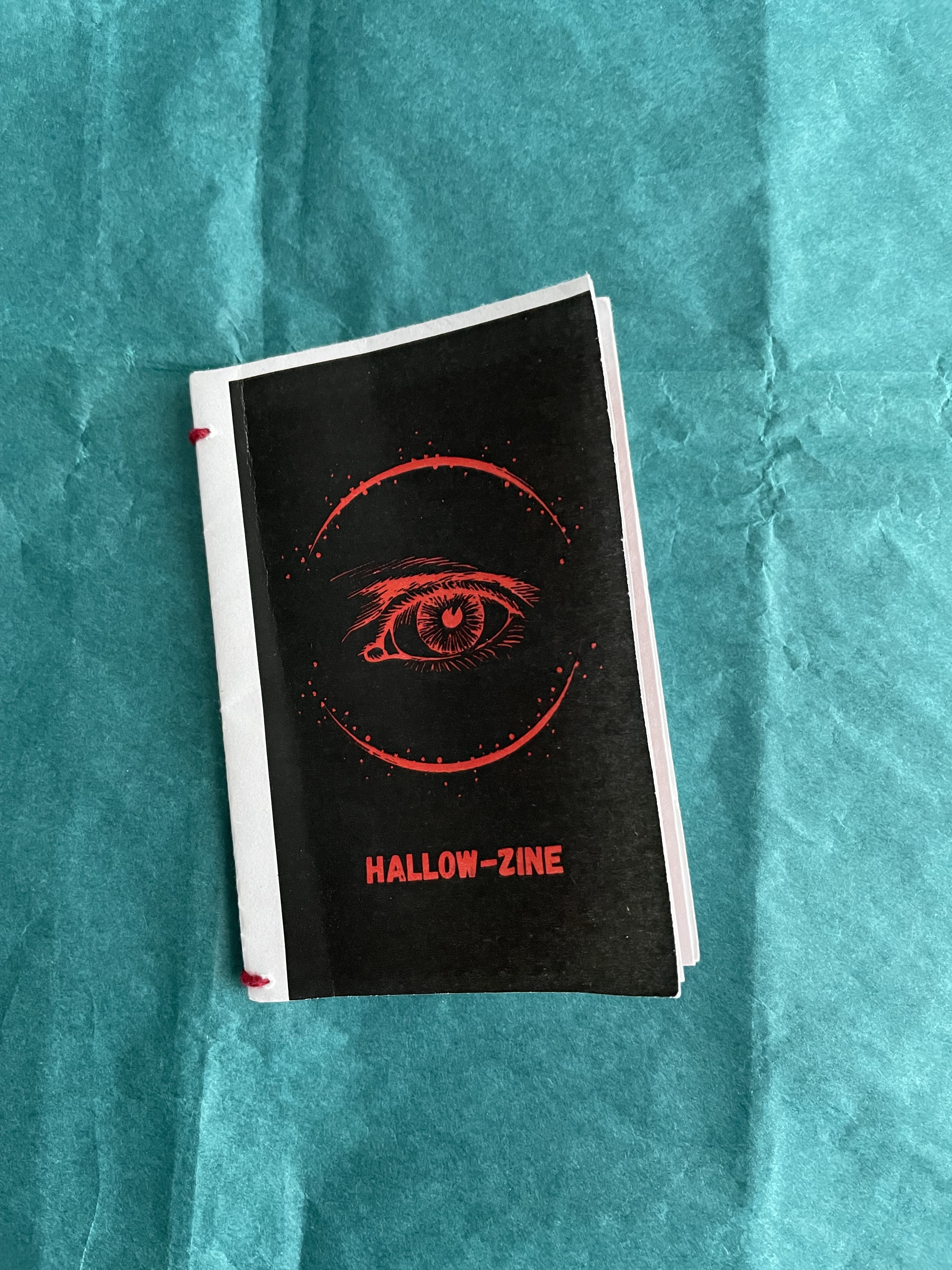 a black zine with a red eye on the cover